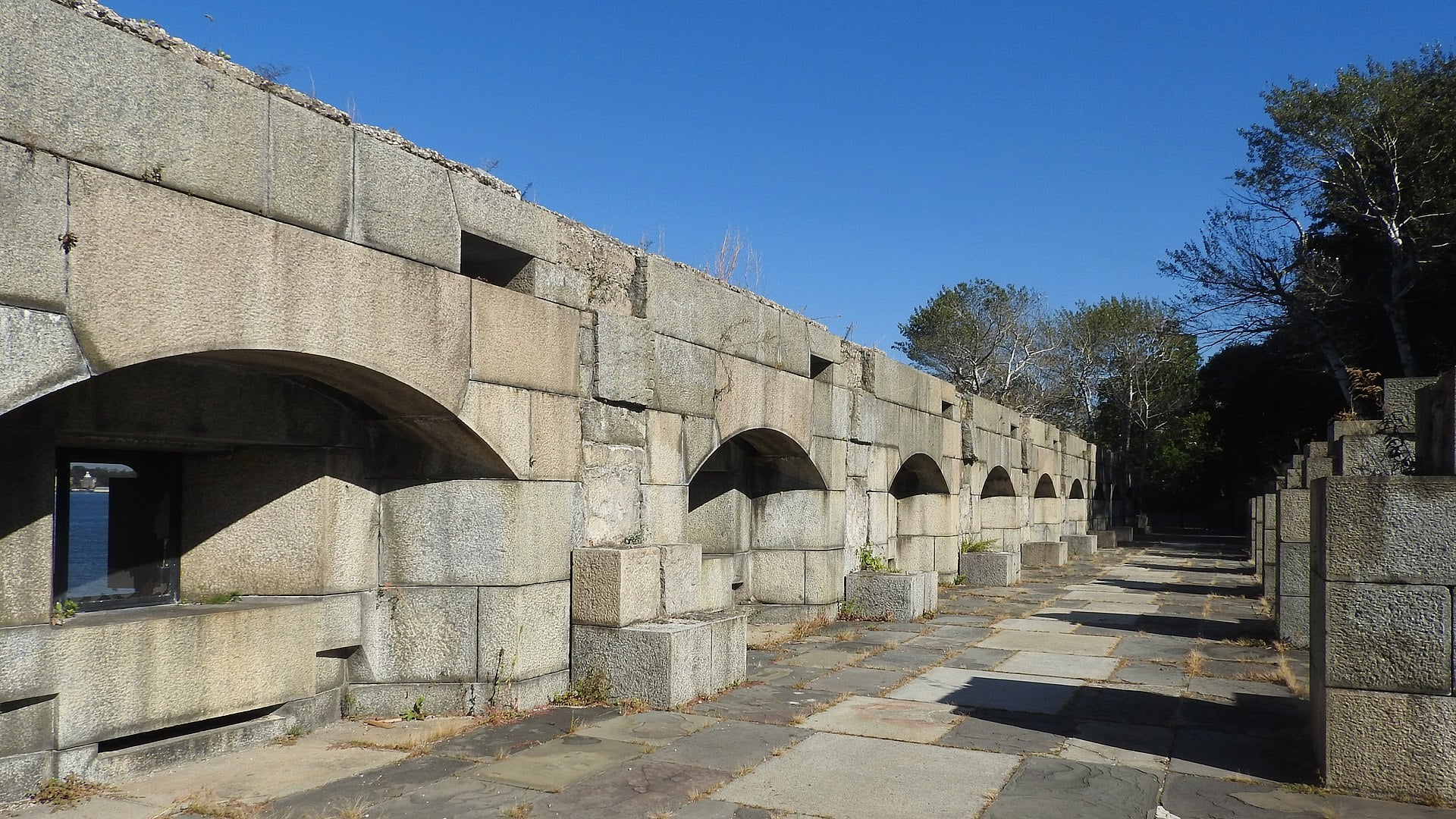 The exterior stone walls of the unroofed Water Battery at Fort Totten, looking east toward Long Island Sound in Bayside, Queens, New York