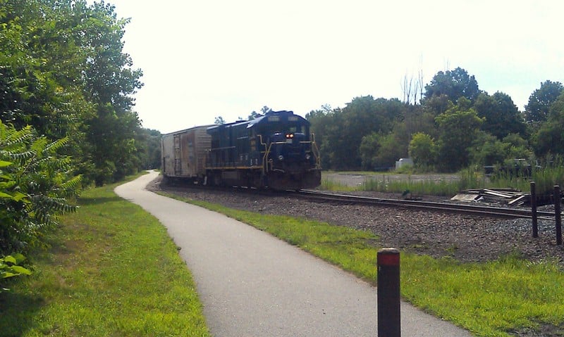 A train passes parallel to the Orange Heritage Trail rail-trail in Chester, Orange County, New York