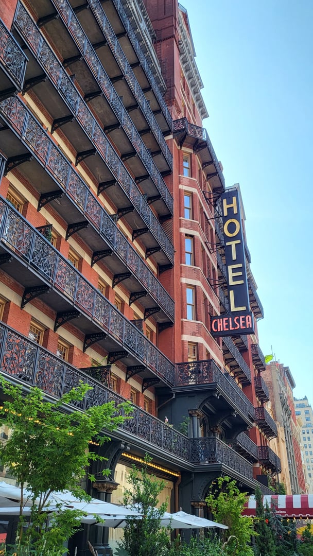 Victorian Gothic brick facade of Hotel Chelsea on West 23rd Street in Manhattan, photographed in 2025