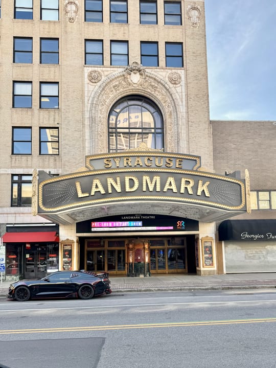 Full daytime street view of the Landmark Theatre (Loew's State Theatre building) at Salina and Jefferson Streets, Syracuse, with the gold 'SYRACUSE LANDMARK' marquee lettering.