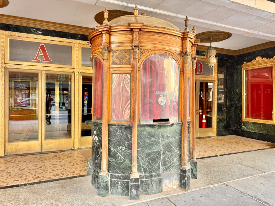 The ornate carved wood and green-marble ticket booth in the Landmark Theatre's entrance lobby, Syracuse, New York.
