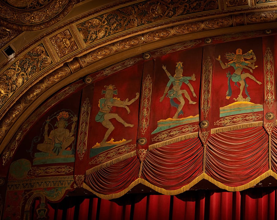 Detail of the auditorium's red-and-gold proscenium at the Landmark Theatre, Syracuse, New York, showing painted Indo-Persian figures; the Landmark (designed by Thomas W. Lamb, opened 1928) is Syracuse's only surviving 1920s movie palace.