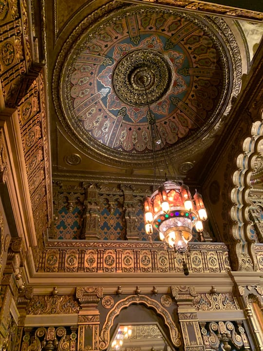 Gilded dome ceiling medallion and ornate chandelier in the Landmark Theatre's lobby, Syracuse, New York.