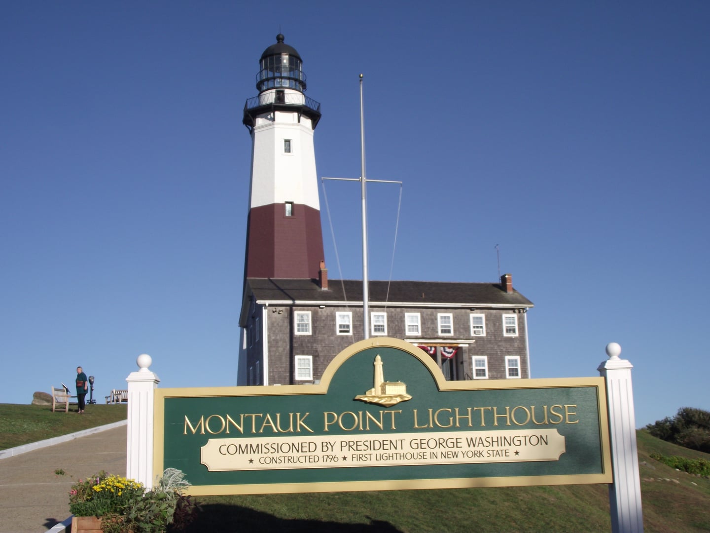 Montauk Point Lighthouse standing at the easternmost tip of Long Island, with rocky coastline in the foreground