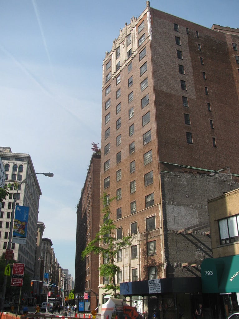 Exterior of NYU Brittany Hall at 55 East 10th Street, a 1929 Gothic Revival apartment hotel across from Grace Church in Greenwich Village