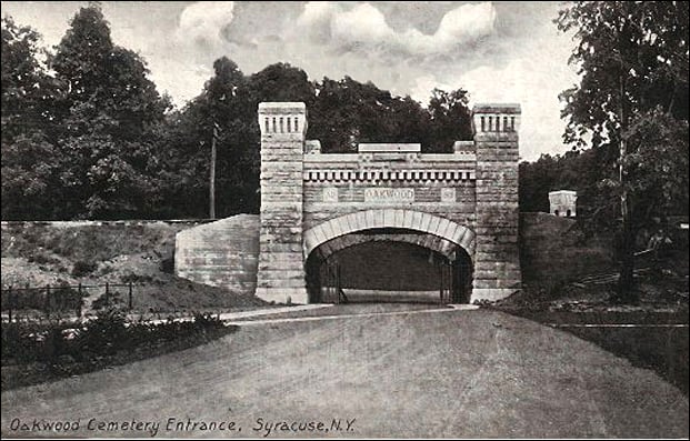 1909 postcard view of the entrance and Victorian monuments at Oakwood Cemetery in Syracuse, New York