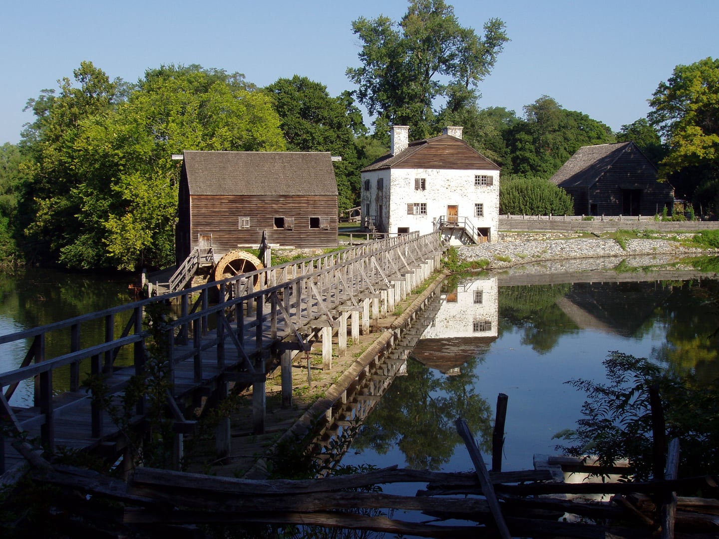 Exterior view of Philipsburg Manor in Sleepy Hollow, New York, showing the stone manor house and mill complex