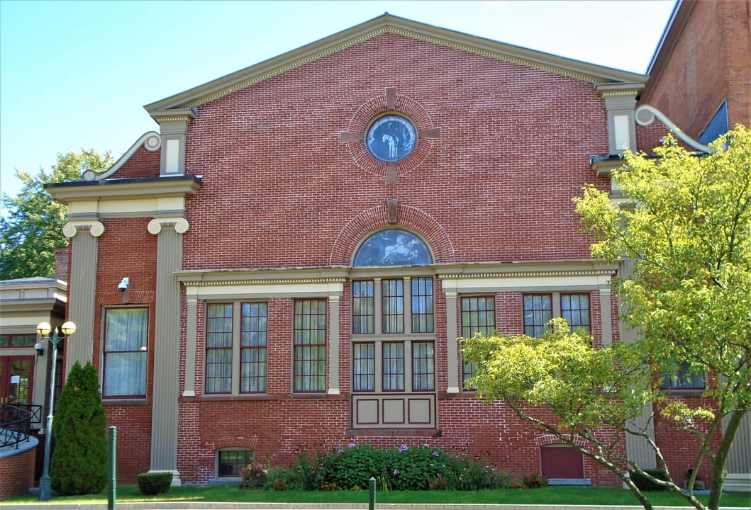 The kitchen and dining wing of the Canfield Casino, a separate brick pavilion with an oculus window.