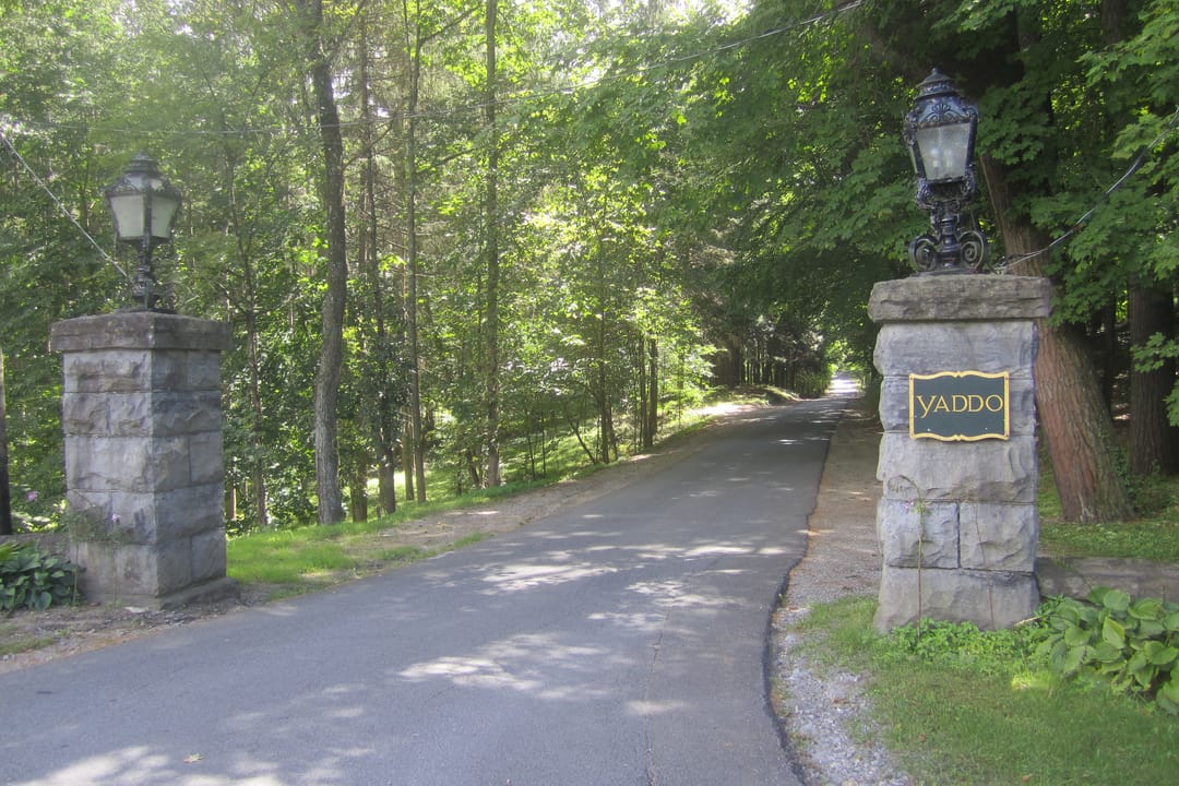 The stone gate posts marking the Union Avenue entrance to Yaddo, Saratoga Springs, N.Y., with the venue's name plate visible.