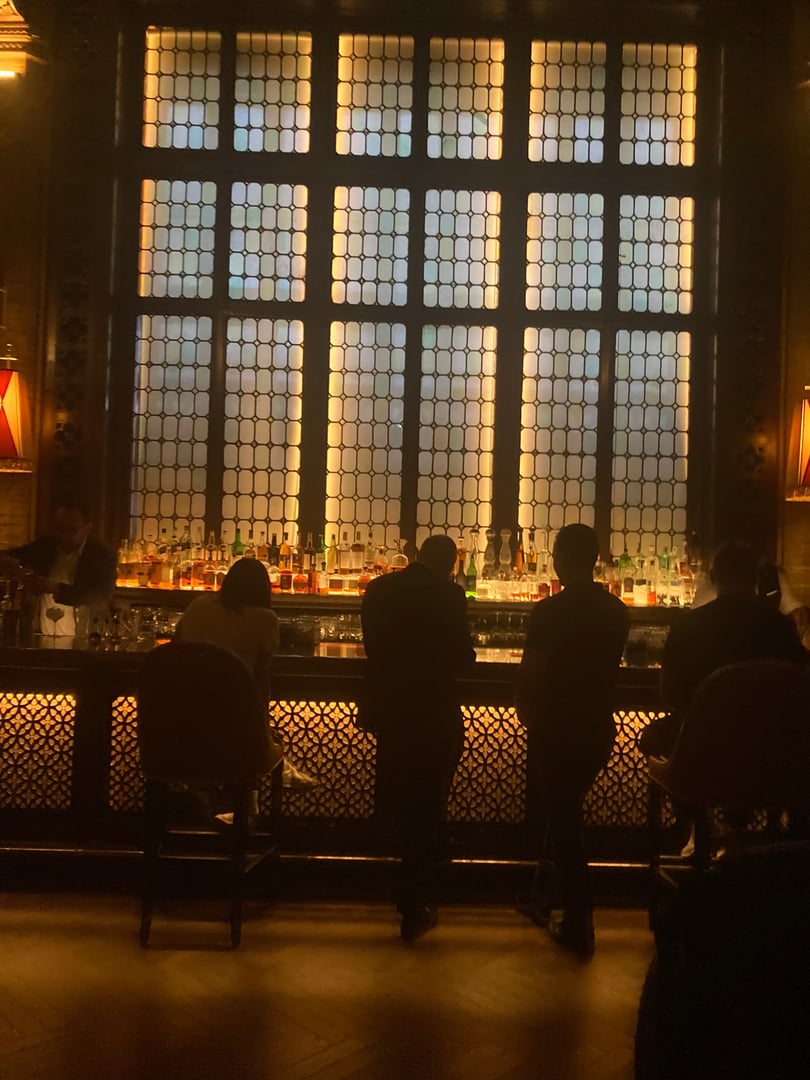 Interior of the Campbell Bar at Grand Central Terminal, showing the ornate 1923 Florentine-style coffered ceiling and mahogany fixtures