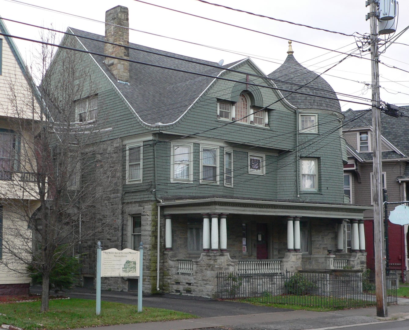 Exterior of the Harlow E. Bundy House at 129 Main Street, Binghamton, showing Queen Anne architecture with conical corner tower