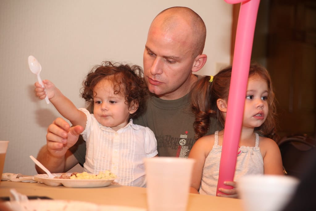 Alison and Isabella Sawyer eat with their father Staff Sgt. Quinn Sawyer, a Center for Naval Avionic Technical Training Marine Unit Instructor, during the quarterly Pig Pickin' at the Cherry Point Hancock Lodge Tuesday Sept. 27. The quarterly Pig Pickin' is an invitation to specific units to come an