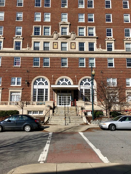 The Battery Park Hotel's arched ground-floor entrance and portico, viewed from the public sidewalk, Asheville, North Carolina.