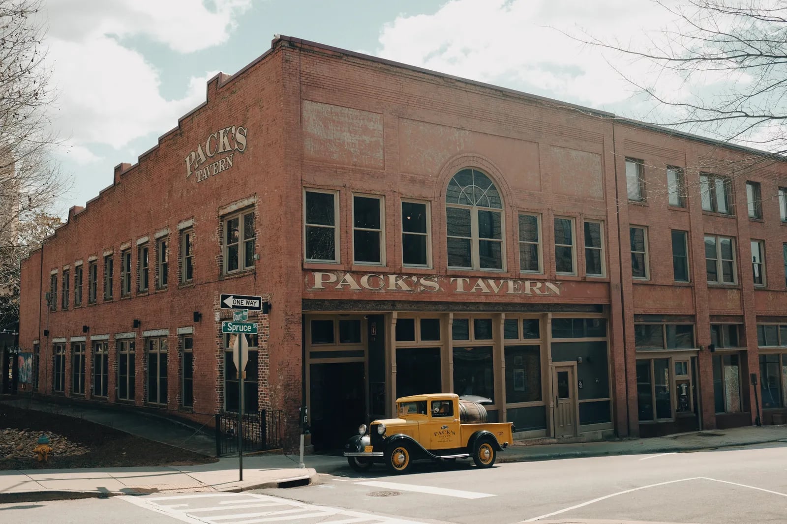 Exterior front facade of the restored 1907 Hayes and Hopson Building housing Pack's Tavern at 20 S Spruce Street in downtown Asheville, North Carolina