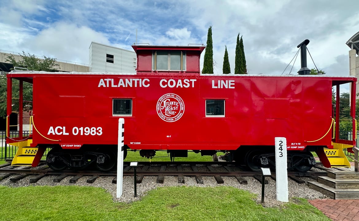 The museum's restored Atlantic Coast Line caboose, ACL 01983, on display track outside the Wilmington Railroad Museum.