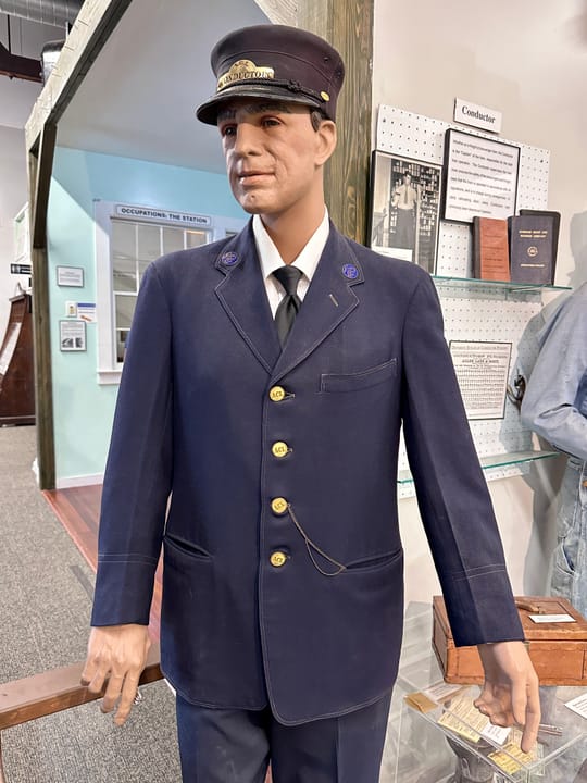 A mannequin in period railroad conductor's uniform, part of the "Occupations" exhibit inside the Wilmington Railroad Museum.
