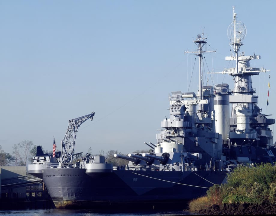 USS North Carolina battleship (BB-55) moored on the Cape Fear River in Wilmington, NC, photographed February 2023 with its 16-inch gun turrets and superstructure visible