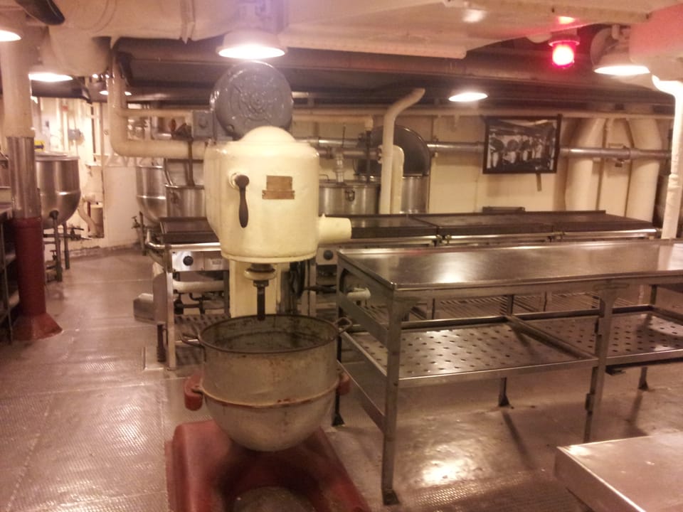The galley aboard the USS North Carolina, with its period mixing and steam-kettle equipment, part of the ship's self-guided museum tour.