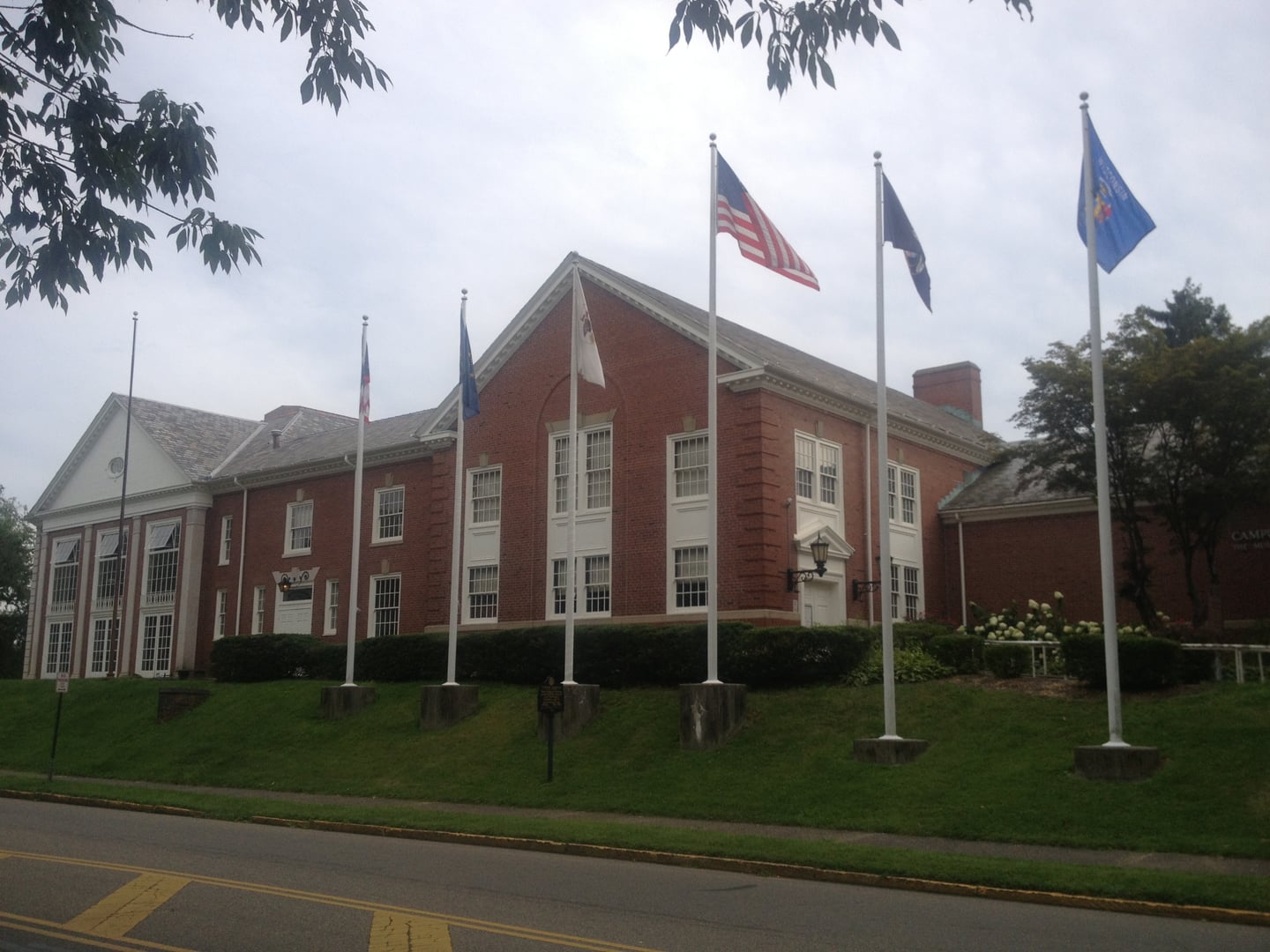 Brick exterior entrance and flag-pole row at the Campus Martius Museum in Marietta, Ohio