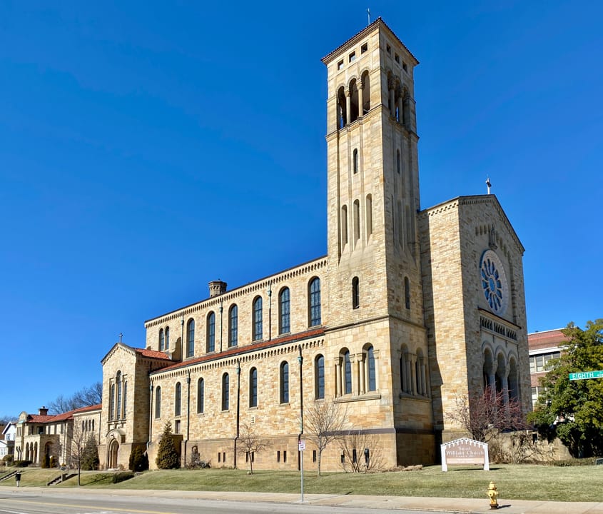 Built between 1929 and 1931, this Romanesque Revival-style church was designed by Joseph Steinkamp to house the congregation of St. William Catholic Church, founded in 1909.  Towering over the corner of West 8th Street and Sunset Avenue, the sandstone-clad church features a red tile roof, roman arch