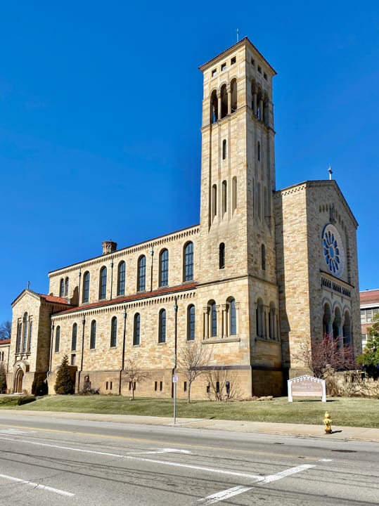 Built between 1929 and 1931, this Romanesque Revival-style church was designed by Joseph Steinkamp to house the congregation of St. William Catholic Church, founded in 1909.  Towering over the corner of West 8th Street and Sunset Avenue, the sandstone-clad church features a red tile roof, roman arch