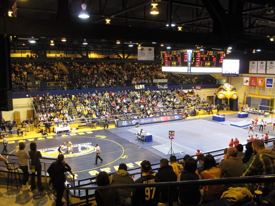 Interior of the Memorial Athletic and Convocation Center for a wrestling and gymnastics meet, known as "Beauty and the Beast", held side-by-side for the first time in the building. The wrestling team defeated Cleveland State and the women's gymnastics team beat Rutgers.