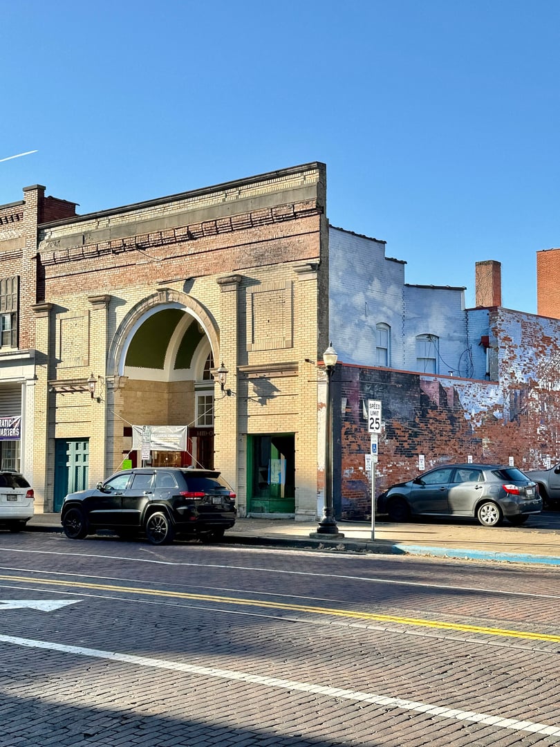Classical Revival 1914 Putnam Theatre building of buff and red brick with four brick Doric pilasters housing the Mid-Ohio Valley Players Theatre at 229 Putnam Street, Marietta, Ohio