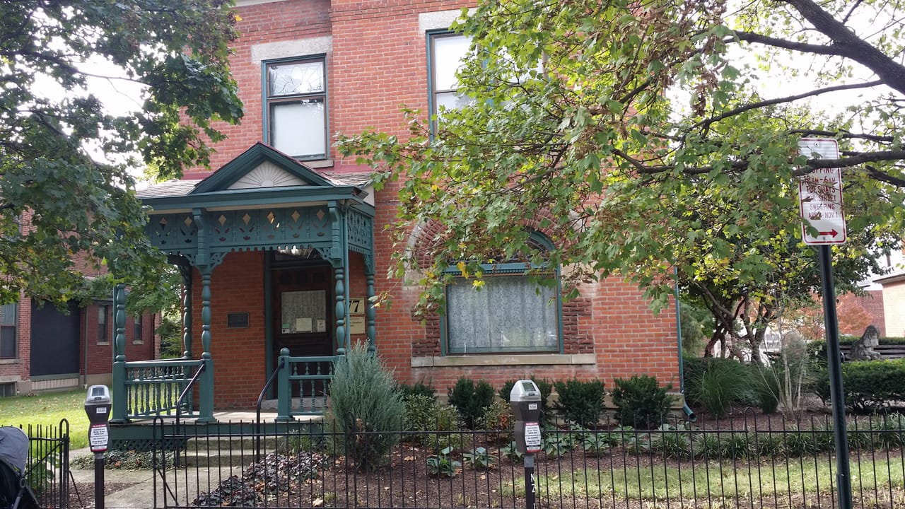 The Thurber House porch and entrance in early fall, Columbus, Ohio, with the "77" address plaque visible by the door.