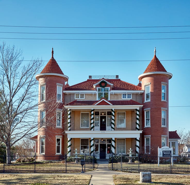 The Belvidere Mansion's twin-turreted front facade and porch, Claremore, Oklahoma, September 2013.