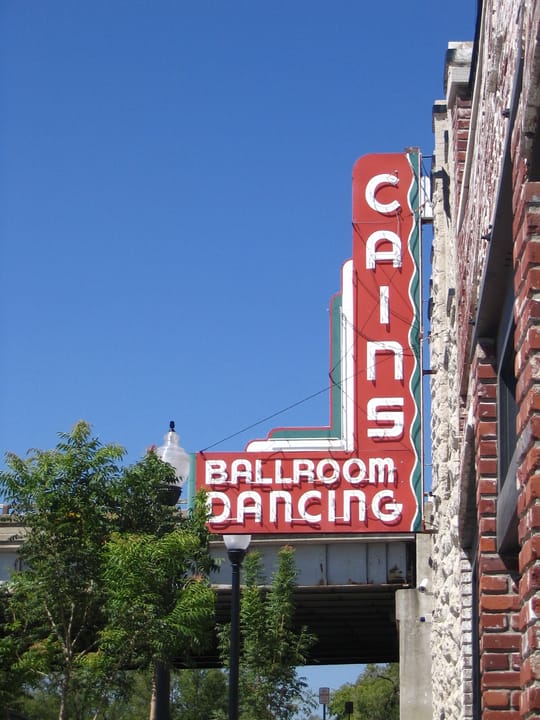 Exterior of Cain's Ballroom on N Main Street in Tulsa, Oklahoma, the 1924 brick western swing dance hall with neon signage.