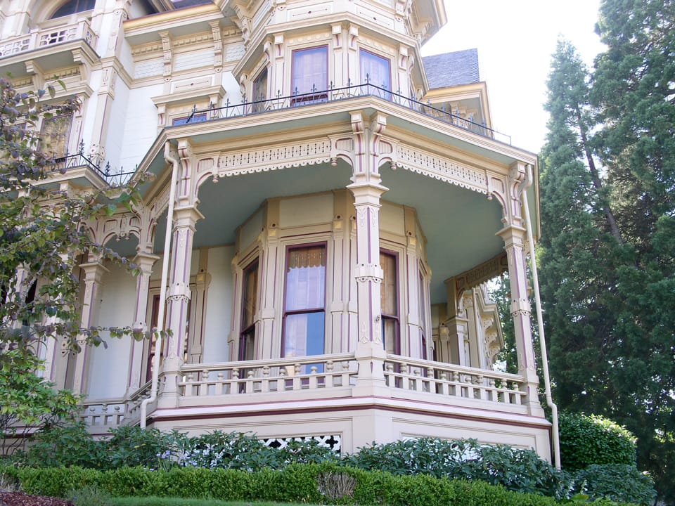 Detail of the Flavel House's wraparound porch, turned columns and decorative millwork