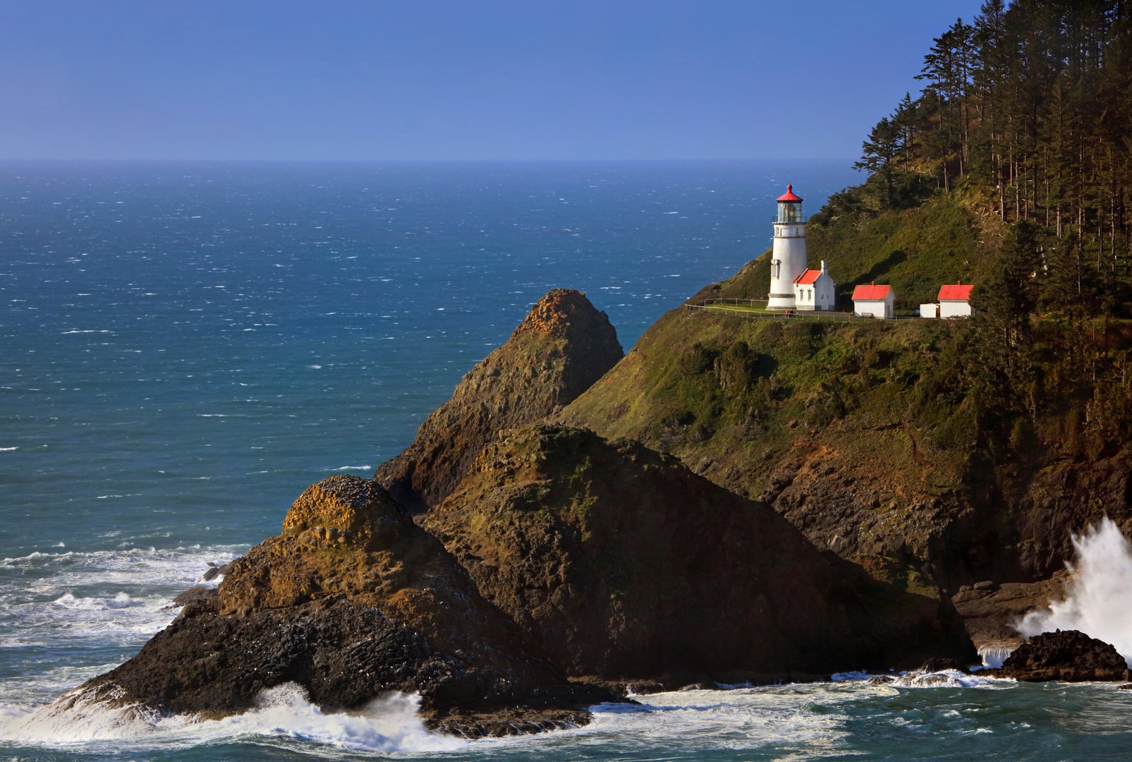 Heceta Head Lighthouse perched on a coastal headland at sunset on the Oregon coast