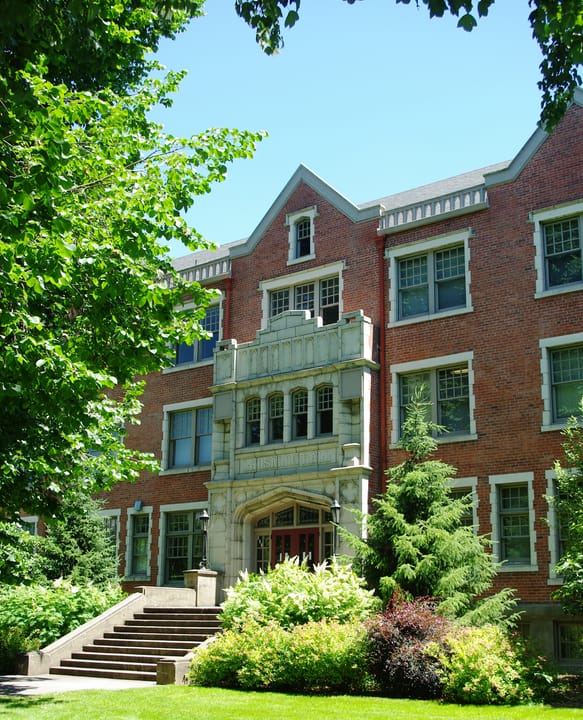 A close view of Lausanne Hall's ornate stone entrance bay and front steps at Willamette University, Salem, Oregon.