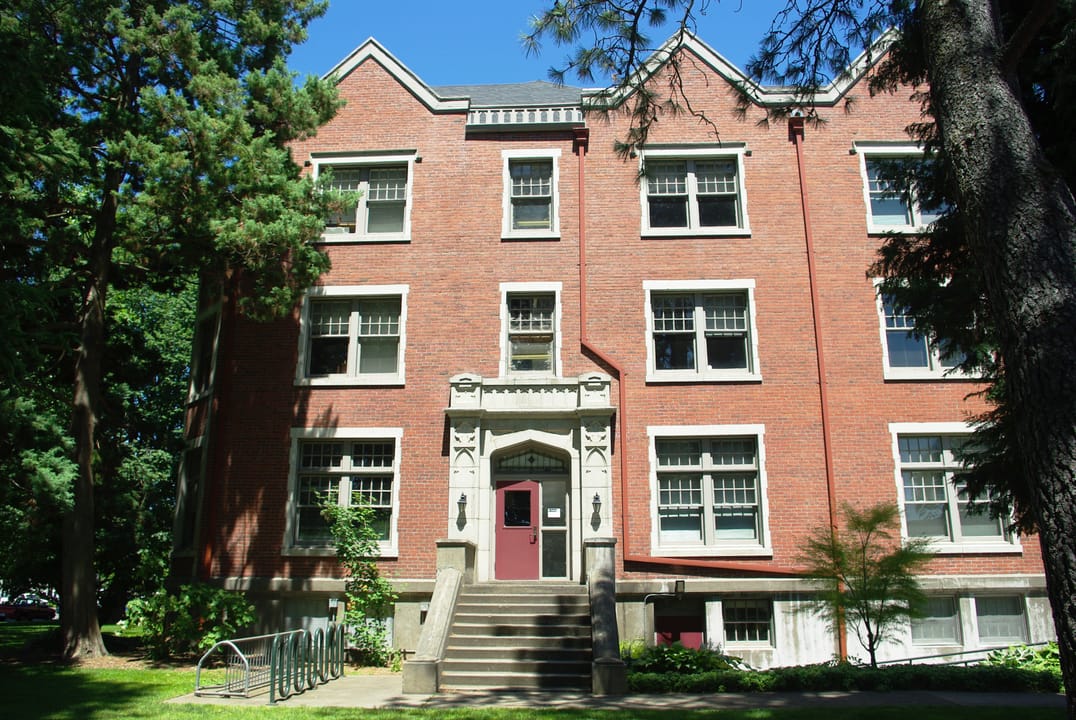 The south side entrance of Lausanne Hall at Willamette University, with its secondary doorway and stone steps.