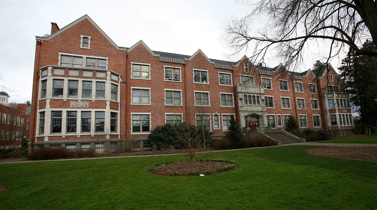 A wide view of the full length of Lausanne Hall at Willamette University in winter, bare trees on the lawn in front.