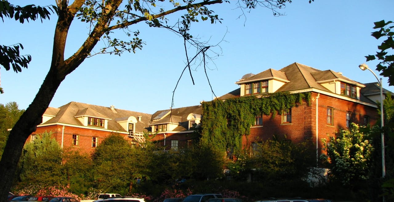 The main lodge of McMenamins Edgefield, the former Multnomah County Poor Farm (built 1911), seen through trees in Troutdale, Oregon.