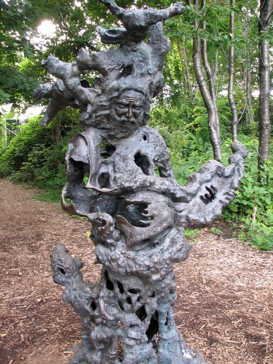 A weathered wood carved-tree sculpture on the McMenamins Edgefield grounds, one of the property's whimsical outdoor folk-art pieces.