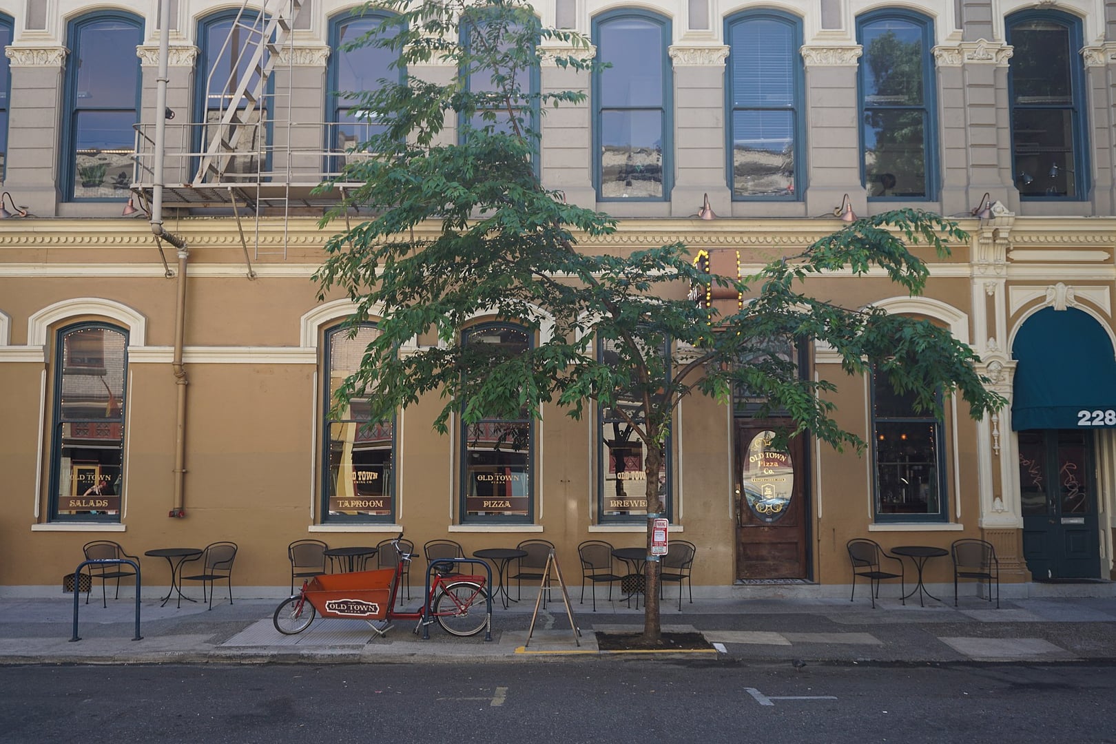 Exterior of the historic Merchant Hotel building housing Old Town Pizza and Brewing at 226 NW Davis Street in Portland, Oregon