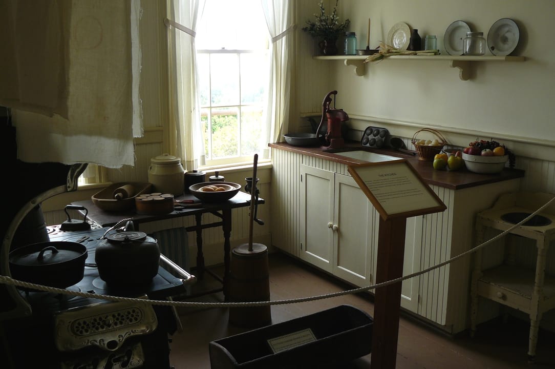 The restored keeper's-era kitchen on public display inside Yaquina Bay Lighthouse, roped off as a museum exhibit, photographed 2013.