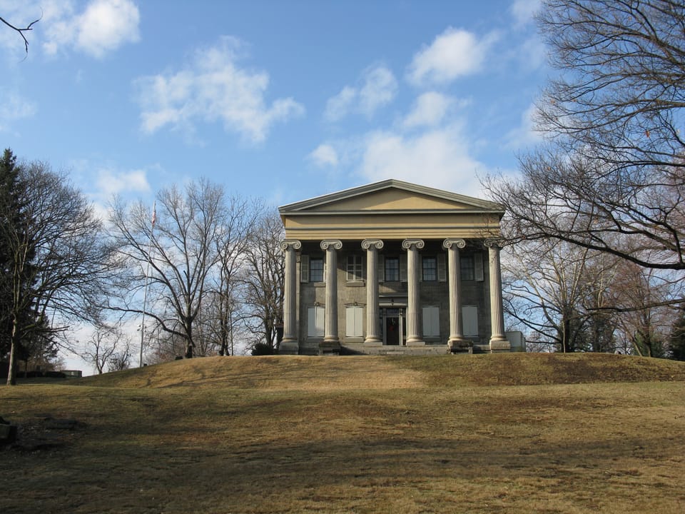 Front elevation of Baker Mansion on its grassy mound, blue winter sky, December 2008.