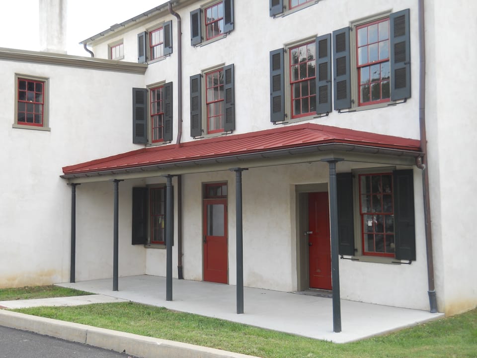 The covered side porch and red door of the Black Horse Inn in Flourtown, Pennsylvania (2012).
