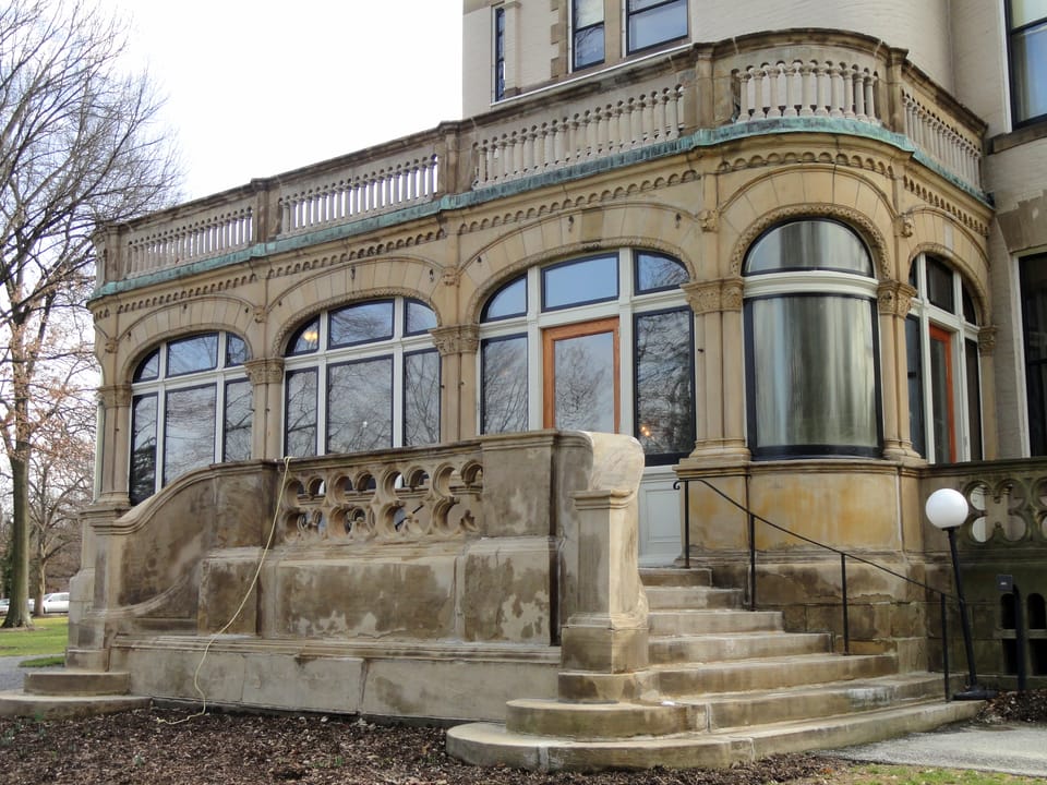 Stone terrace and arched conservatory windows on Clayton's garden side, with the curved balustraded porch above, March 2012.