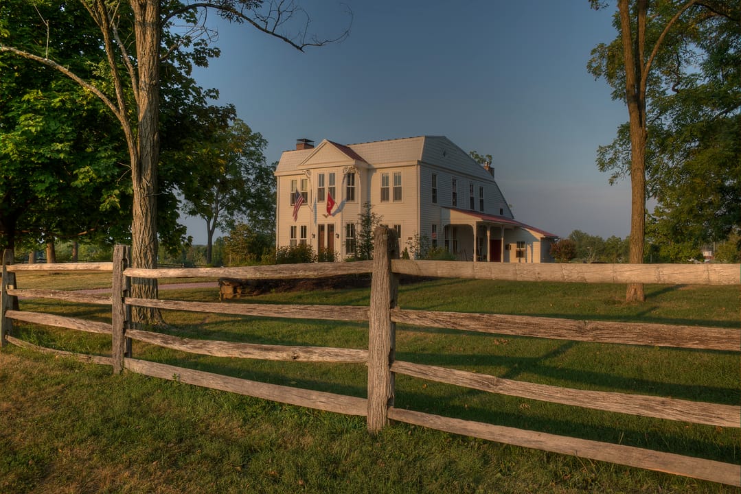The McMillan House, a farmhouse within Gettysburg National Military Park used as a field hospital during the 1863 battle, seen behind its split-rail fence.