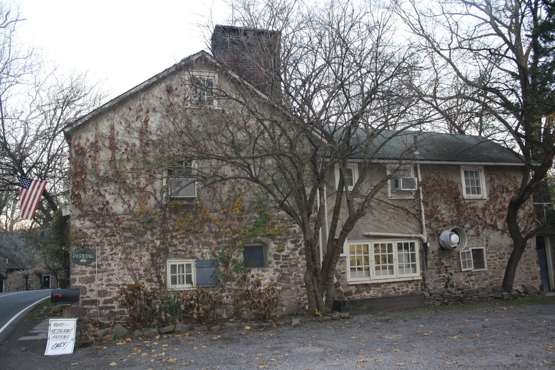 The Inn at Phillips Mill, gable end with chimney and restaurant-parking signage, New Hope, Pennsylvania (2012).