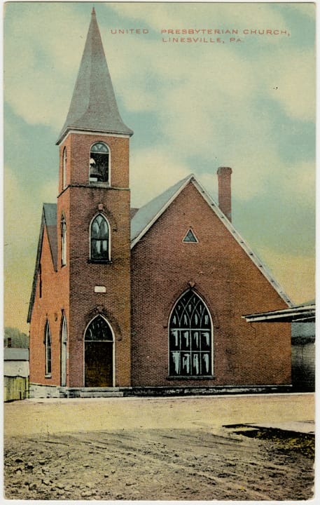 Three-story 1882 brick hotel with arched windows on West Erie Street in Linesville, Pennsylvania