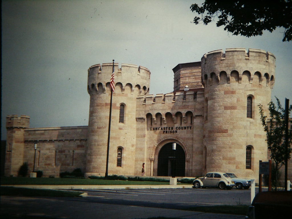 Lancaster County Prison's 1851 limestone exterior with crenellated towers and faux portcullis on East King Street.