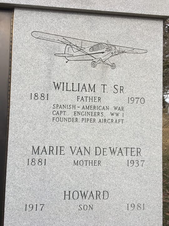 Close up of mausoleum featuring a Piper Cub and husban and wife William and Marie.