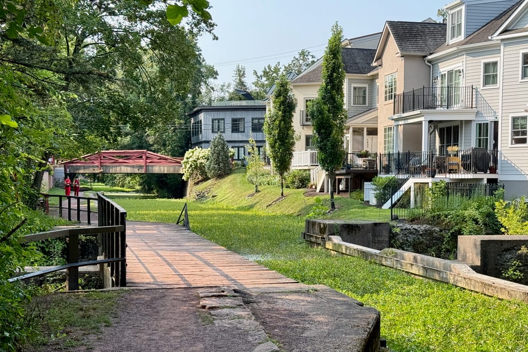 The Ingham Creek Aqueduct, also known as the Aquetong Creek Aqueduct, on the Delaware Canal in New Hope, Pennsylvania. The Mechanic Street Bridge is in the background.
