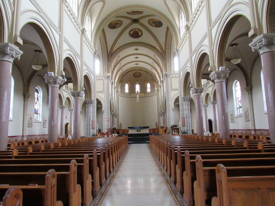 Exterior of Saint Vincent Archabbey Basilica in Latrobe, Pennsylvania, with the statue of founder Archabbot Boniface Wimmer in the foreground