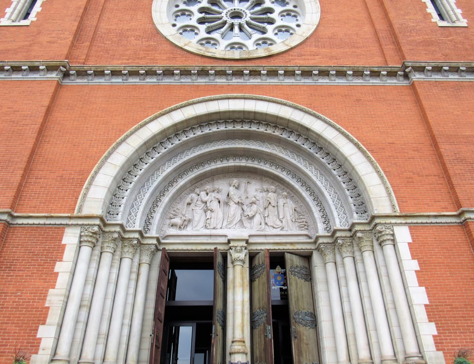 The rose window and sculpted Romanesque Revival main portal of Saint Vincent Basilica, Latrobe, Pennsylvania.